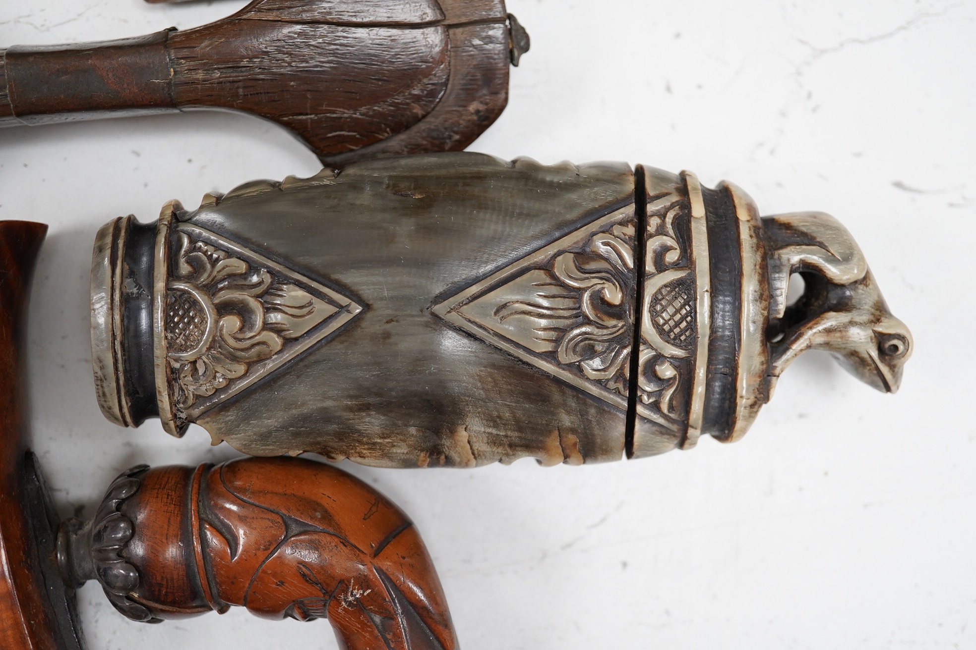 Two Kris daggers, a jambiya dagger and an Indonesian horn powder flask, longest 41.5cm. (4). Condition - poor to fair